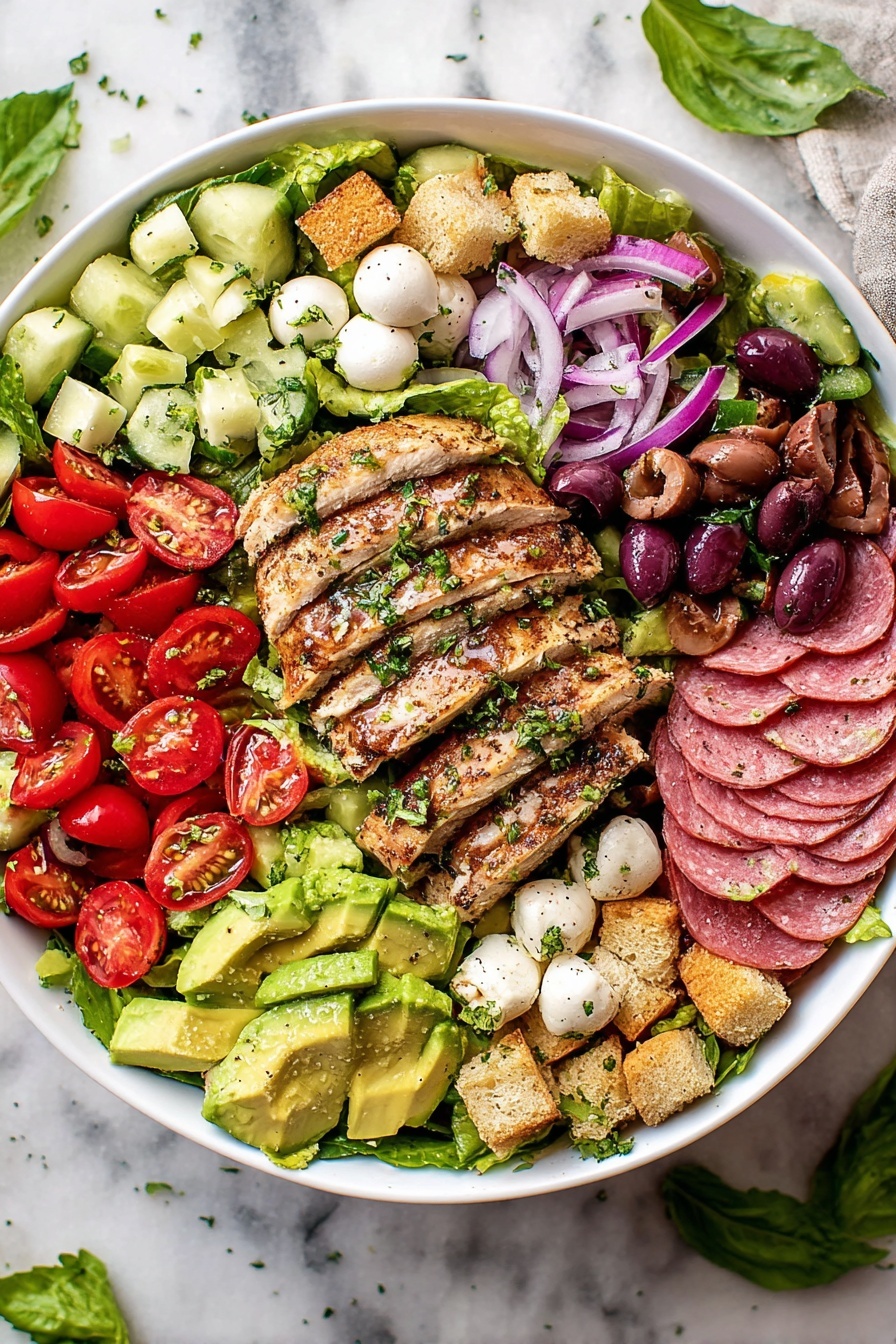 A large white bowl filled with several layers of fresh ingredients starts with a base of green leafy lettuce. On top, slices of grilled chicken with a browned surface and sprinkled green herbs are layered in the center. Around the chicken, there are sections of bright red cherry tomato halves, light green cucumber chunks, deep purple olives, thin red onion rings, and pale green avocado slices, also topped with green herbs. Small round white mozzarella balls and golden brown croutons are scattered evenly over the salad. On one side, there are folded slices of pink salami arranged neatly. The bowl sits on a white marbled surface with a few basil leaves and some lettuce pieces nearby. photo taken with an iphone --ar 2:3 --v 7
