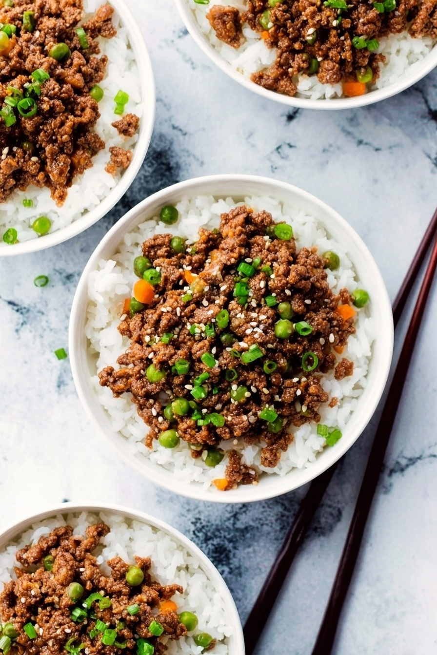 The image shows four white bowls placed on a white marbled surface, each filled with two layers. The bottom layer is white steamed rice with a soft, fluffy texture. On top, there is a generous layer of cooked ground beef mixed with small pieces of orange carrot and tiny green peas, creating a mix of brown, orange, and green colors. The beef is garnished with chopped green onions and sprinkled with small white sesame seeds. Two dark brown chopsticks rest on the surface next to one bowl. Photo taken with an iphone --ar 2:3 --v 7
